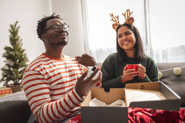 istock Couple opening Christmas  presents at home 2183456205