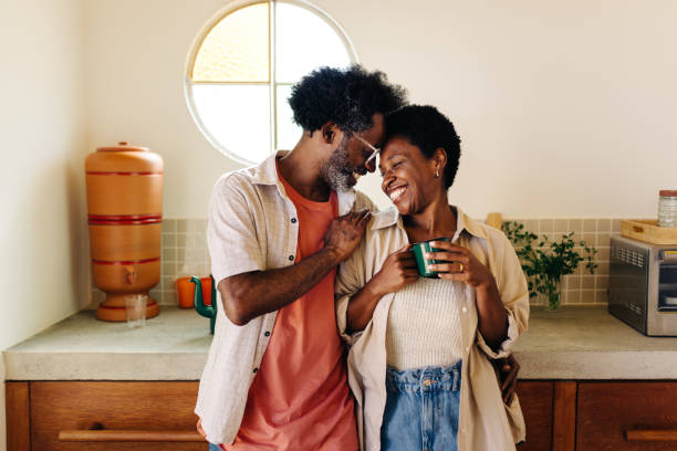 istock Mature couple looking in love in their home kitchen 2183456960