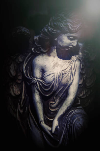 Old and ancient partently destroyed statue: angel with wings.