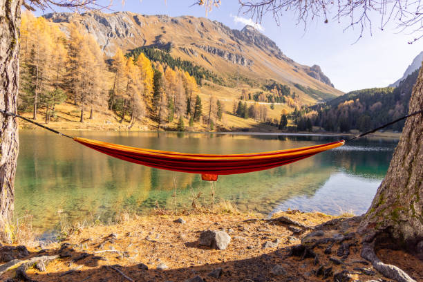 istock Empty Hammock Overlooking Scenic Lake and Autumn Mountains 2183459766