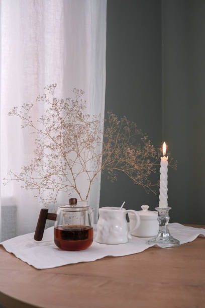 istock A Cozy Tea Setup Featuring a Beautiful Candle and Delicate Dried Flowers for Ambiance 2183460019