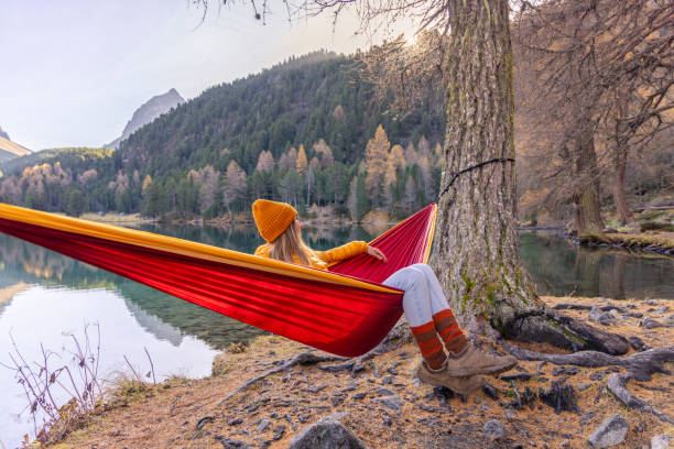 istock Relaxing in a Hammock by a Tranquil Autumn Lake 2183460110