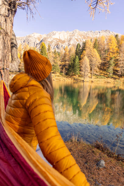 istock Relaxing in a Hammock by a Mountain Lake in Autumn 2183460255