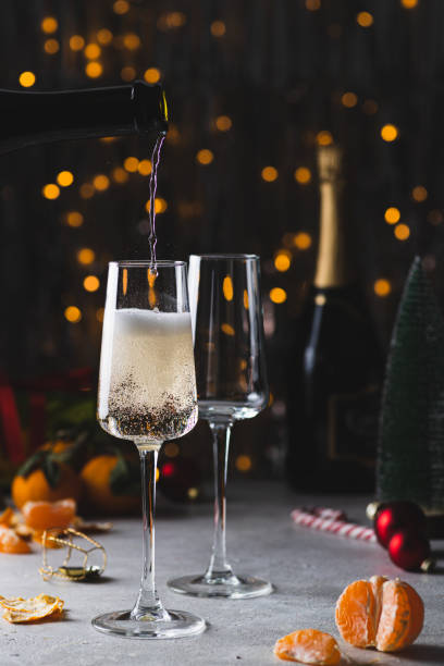 istock Champagne is poured into a glass from a bottle 2183461547