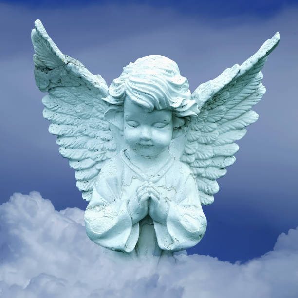 istock Beautiful little angel praying on a cloud in the sky. 2183461721