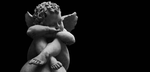 Little angel. Ancient stone statue. Copy space for design or text. 17th century, street architecture of Lviv, Ukraine.
