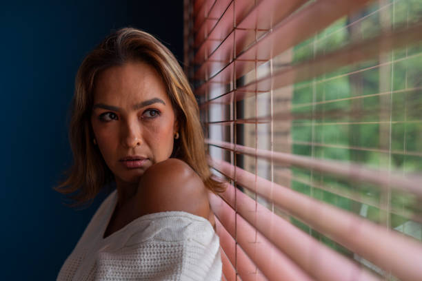The Latin woman from Bogota Colombia, between 40 and 44 years old, likes to look out the window on a nice morning