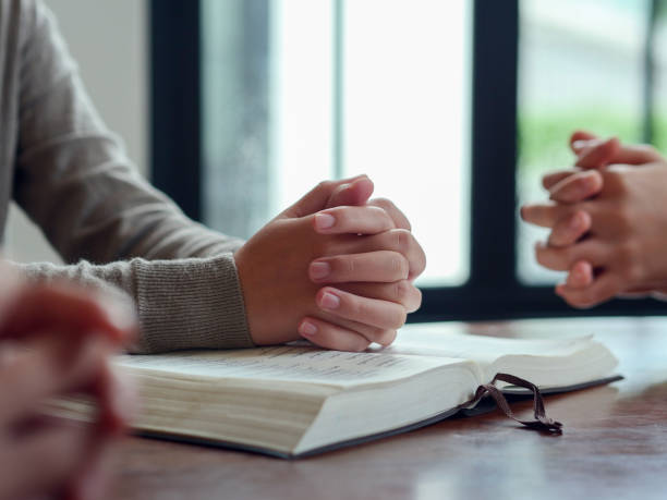 istock Group of different women praying together, Christians and Bible study concept. 2183466362