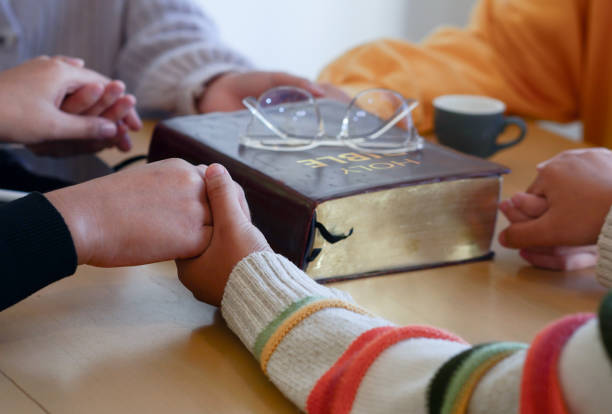 Christian groups hold hands to bless and pray for each other.