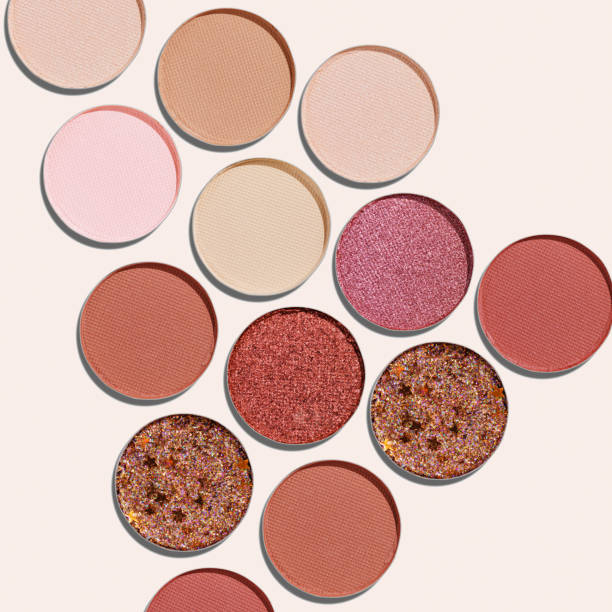 istock Cosmetics texture pattern, Warm vivid colored eye shadow makeup palette, round eye powder swatches. Female cosmetic and beauty products, aesthetic minimal beauty photo, colorful eyeshade, top view 2183467245