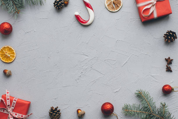 istock Christmas composition. Gifts, pine cones, fir branches, candy, spices and other decorations on vintage gray background. Flat lay, top view. 2183469119