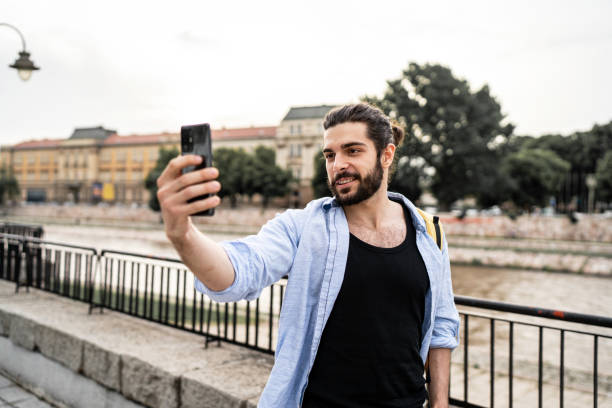 istock Young man records a video with a camera in a city 2183469661