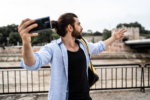 istock Young man records a video with a camera in a city 2183469758