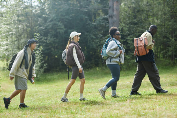 istock Tourists Walking in Row on Trail 2183472533