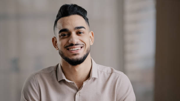istock Portrait of confident calm young man arabic ethnic male handsome brunet guy turn head at camera happy male human bearded face positive smiling hispanic millennial businessman shows toothy health smile 2183473172