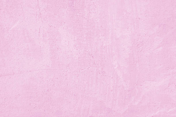 Pink wall of the building. Rough plaster surface. Abstract background.
