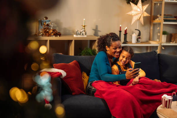 istock Mother and daughter smiling while on a video call 2183474958