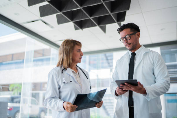 istock Doctors talking and looking x-ray image at hospital 2183475822