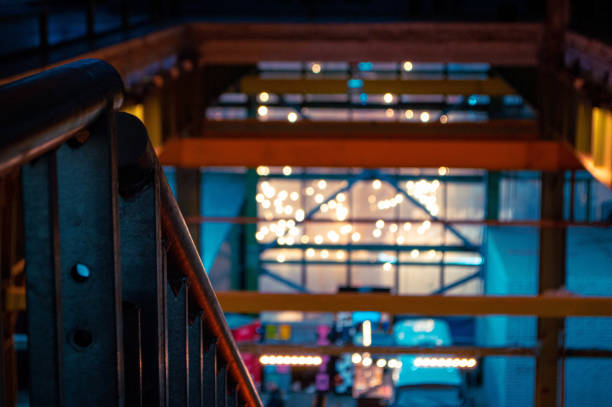 The premises of an old industrial building. Staircase with illumination. Light decorations. The old workshop of the factory.