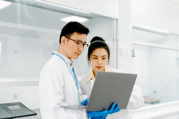 istock Two Asian scientists working on computer for research, medical report and data analytics in laboratory. Healthcare, teamwork and female scientist in discussion for analysis, results and biotechnology. 2183480288