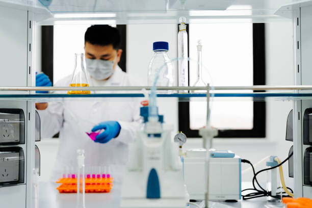 istock Young Asian male scientist conducting an experiment in laboratory. 2183480666