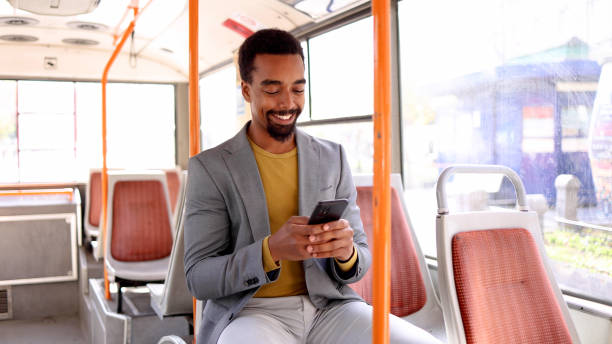istock Passenger checking messages on his phone while traveling on the bus 2183481626