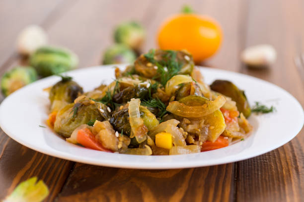istock Brussel sprouts cooked with vegetables, on a wooden table 2183481893