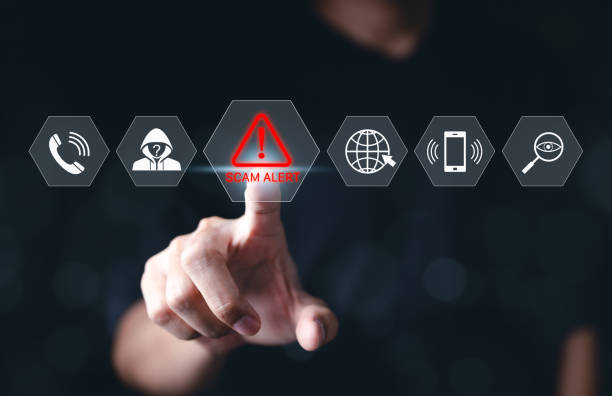 cybersecurity scam alert warning concept. a hand interacts with a virtual interface displaying icons for scam alert, fraud detection, and online security, cybersecurity awareness and fraud prevention. - oplichten stockfoto's en -beelden