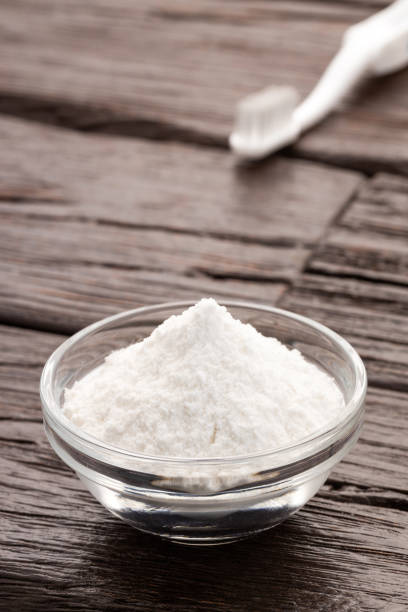 istock Baking soda in bowl and toothbrush - Wooden background. 2183488131