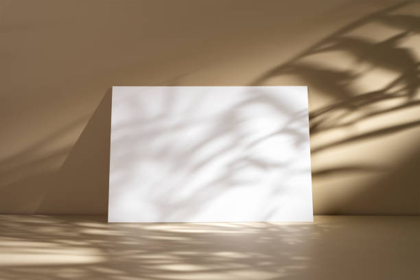 istock Minimalist beige background with a blank white poster, creating contrast and shadow play 2183488391