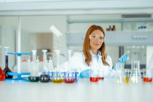istock Female Scientist With Protective Goggles Looking at Camera in Modern Laboratory 2183489053