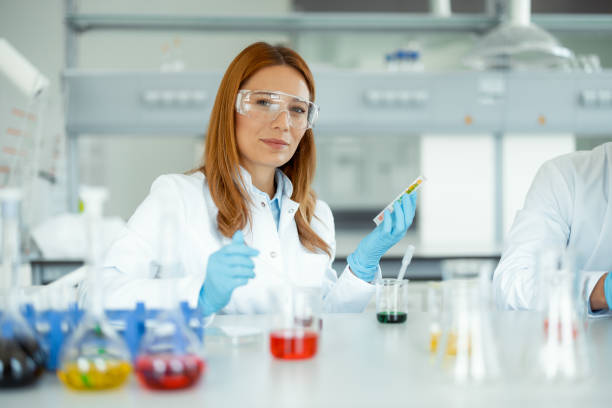 istock Female Scientist With Protective Goggles Looking at Camera in Modern Laboratory 2183489081