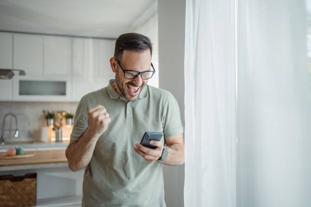 istock Surprise on the screen, the handsome man discovers that he has been paid 2183489585