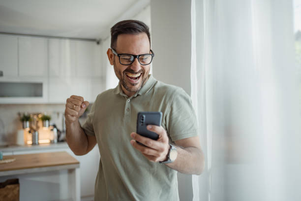 istock Surprise on the screen, the handsome man discovers that he has been paid 2183489590