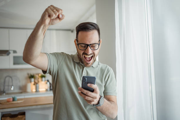 istock Surprise on the screen, the handsome man discovers that he has been paid 2183489606