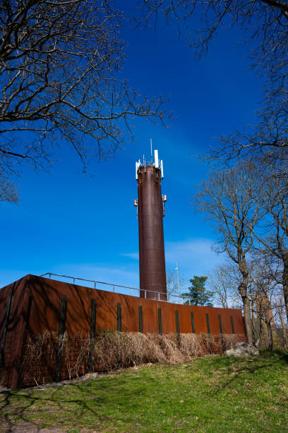 istock Mobile telephone base tower and district heating funnel.. 2183490298