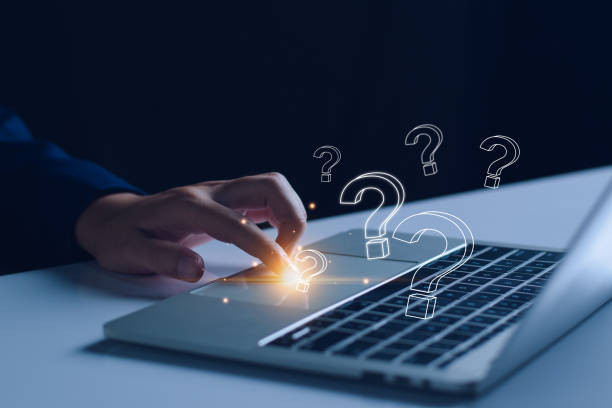 istock FAQ concept, ask questions, find answer online in customer support. Business man use tablet answering customer questions online, FAQ. Online service gives quick answers. 2183490879