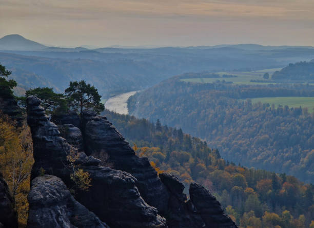 climbers climb logs on high pyramidal rocks. your warm clothes on your sleeping bags, backpacks and water and food will stay under the ski overhang