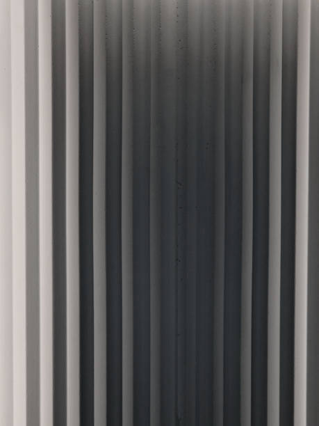 istock stucco wall with stripes reminiscent of folded fabric with triangle scratches stacked and a relief appearance of illuminated shadows. 2183495279