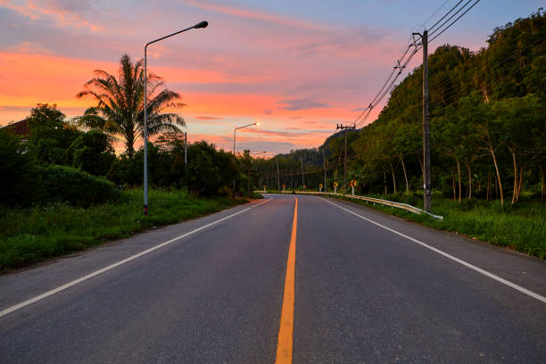 istock Silhouette of Dramatic sky during sunset over asphalt road 2183498025