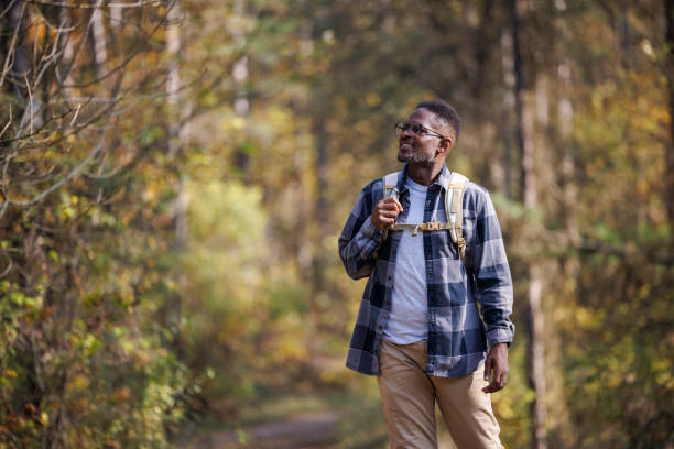 istock Portrait of smiling man hiking through a forest 2183499013