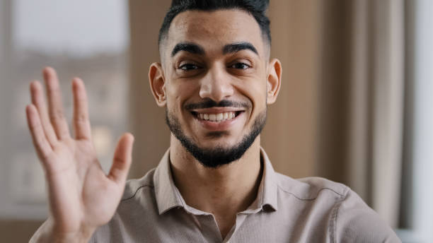 istock Hispanic handsome business man millennial wave hand greet look at camera arab friendly guy record lifestyle blog provide distance tutorial educational course use internet online video web application 2183500043