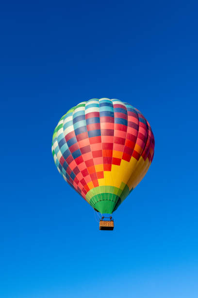 istock Kubicek Balloons Hot Air Balloon Soaring in Clear Blue Sky 2183500631