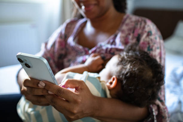 istock Young mother using a phone with her son at home 2183501839