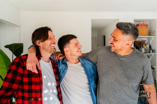 istock Male friends embracing and talking at home 2183502014
