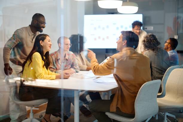 istock Beautiful colleagues talking about work at a business meeting 2183504975