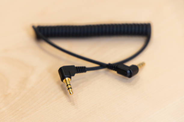istock Close-up of Camera Audio Cable (3.5mm TRS) on Wooden Table 2183507383