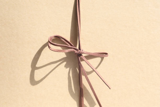 a box on a white background with a ribbon of mocha mousse color