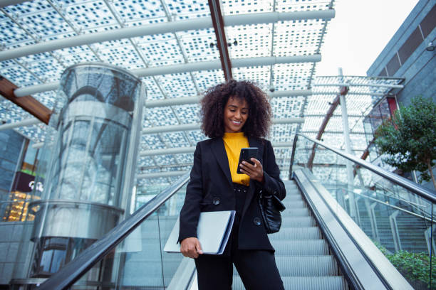 istock Cheerful businesswoman using her smart phone outside 2183509339