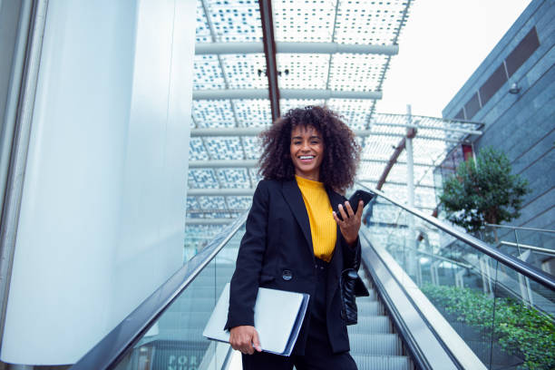 istock Cheerful businesswoman using her smart phone outside 2183509467